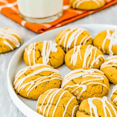 Eggless Pumpkin Cookies on a plate with a glass of milk on the background