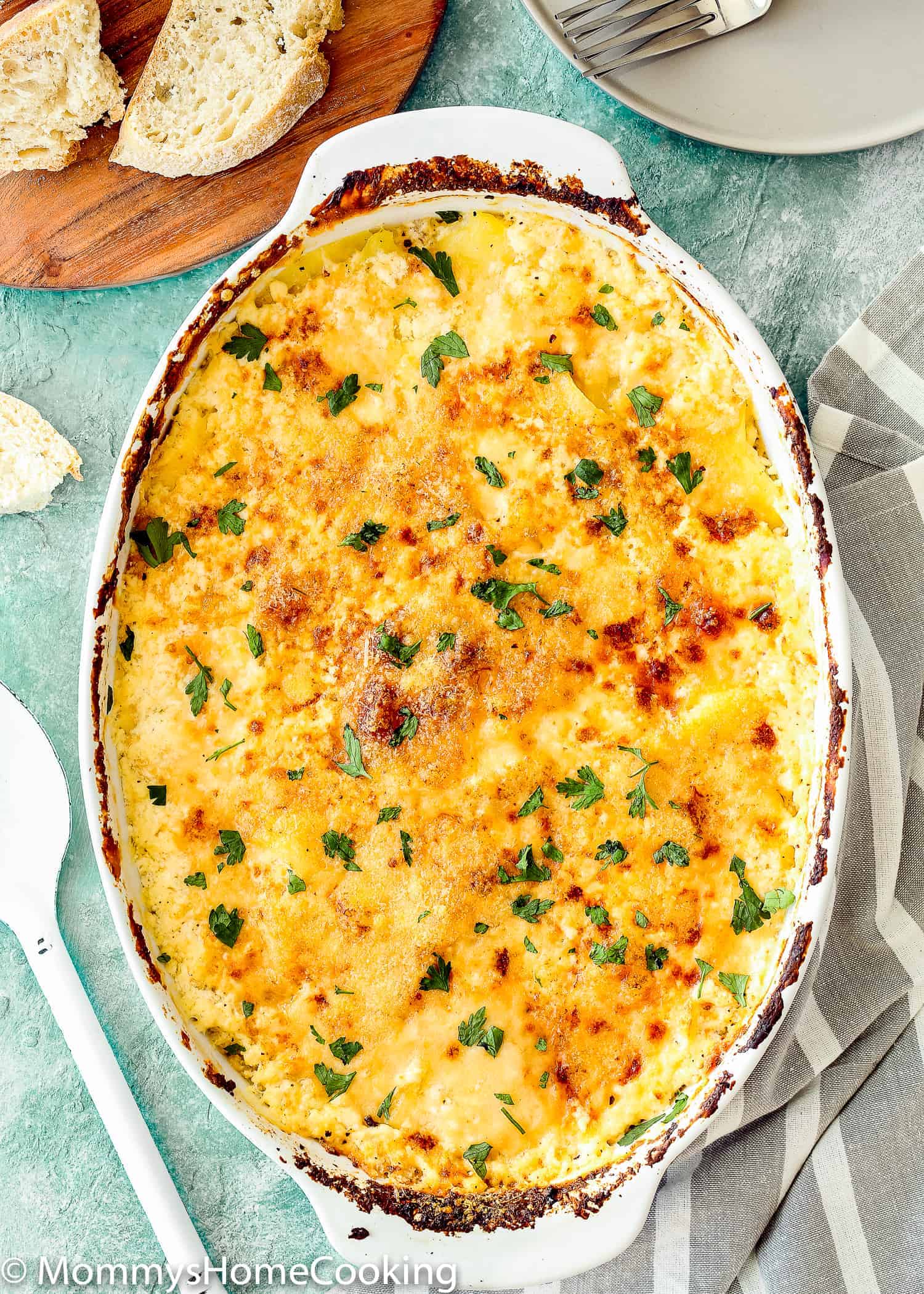 This Cheesy Potatoes and Cod Casserole recipe is cheesy, creamy, and easy to make! Loaded Potato, cheese and cod, this dish is a whole dinner in one! For sure a go-to dinner for any day of the week. https://mommyshomecooking.com