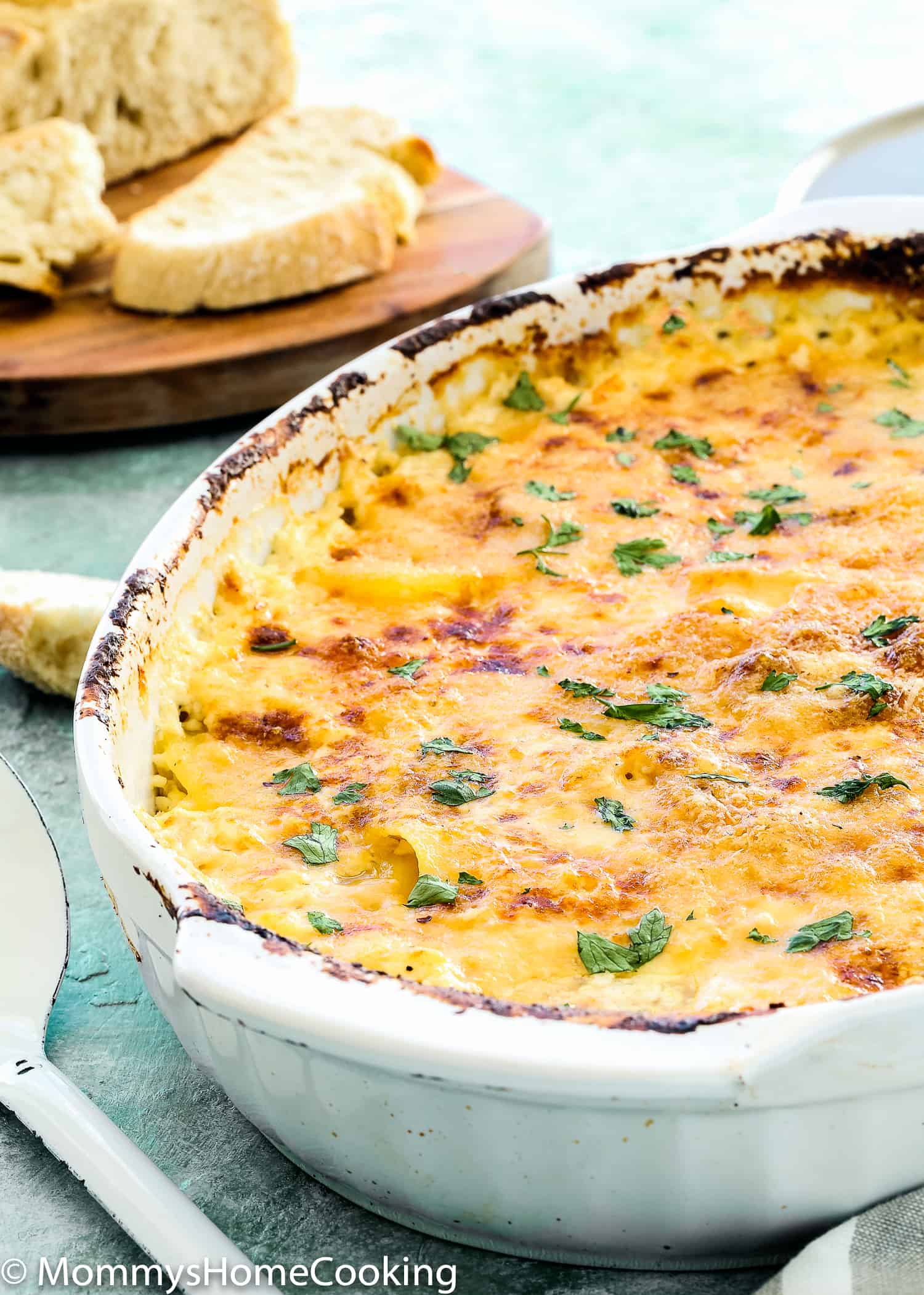 This Cheesy Potatoes and Cod Casserole recipe is cheesy, creamy, and easy to make! Loaded Potato, cheese and cod, this dish is a whole dinner in one! For sure a go-to dinner for any day of the week. https://mommyshomecooking.com