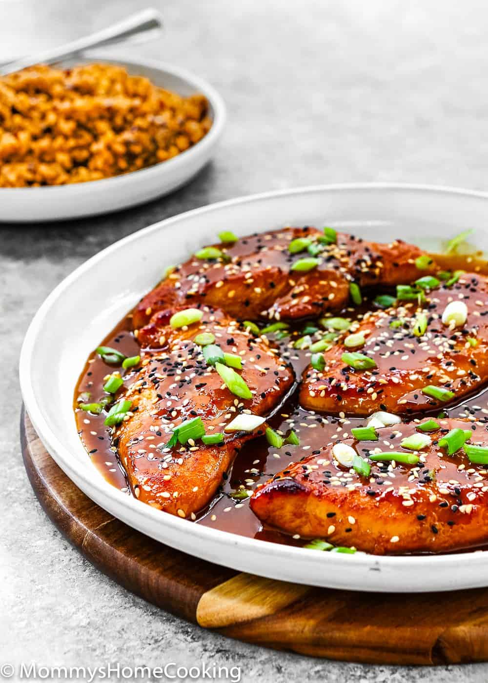 Easy Asian-Style Chicken Breasts in a white skillet  with a side of rice