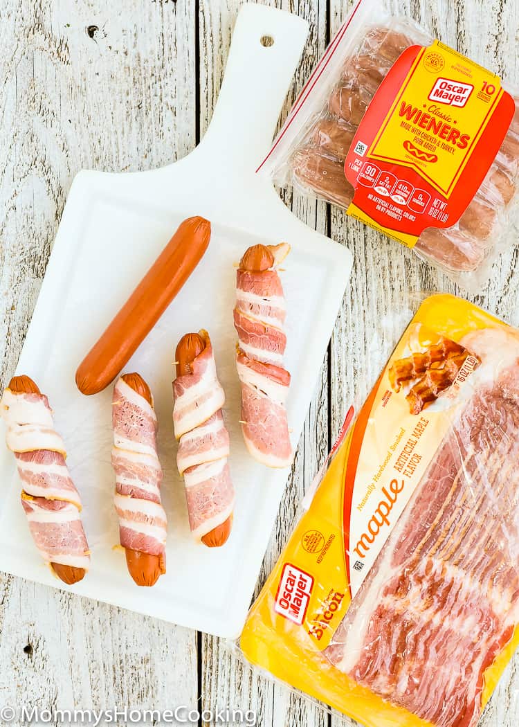 These Easy Bacon-Wrapped Hot Dogs are perfect for a summer weeknight dinner!! Topped with tomato, onion, and jalapeno, this hot dog is a deliciously easy way to say bye-bye to the Ol’ boring bun.