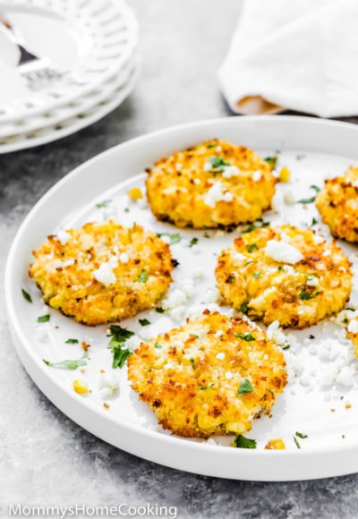 egg-free corn fritter on a plate sprinkled with cheese and chopped cilantro.