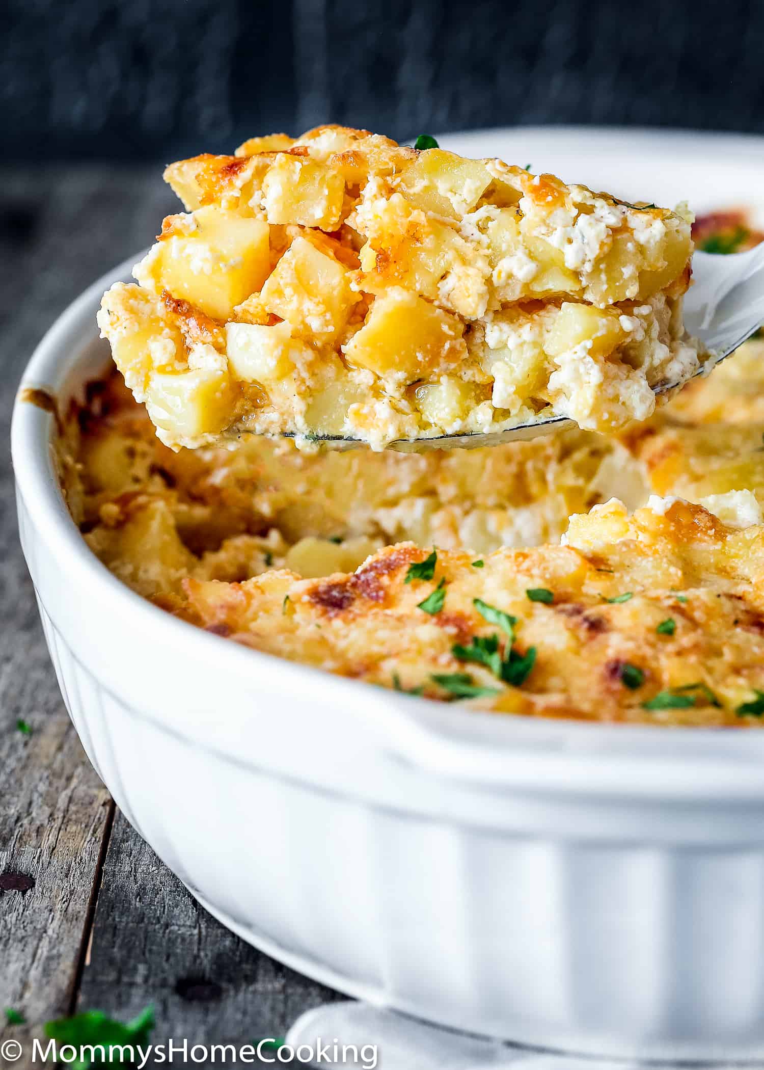 a spoon holding Cheesy Hash Browns. 