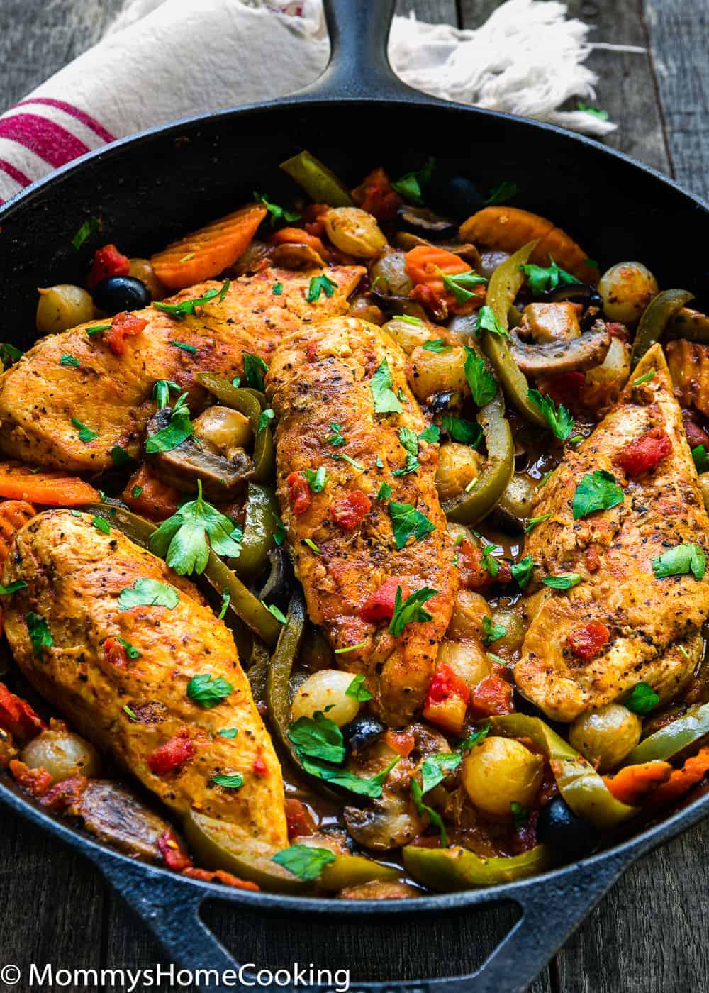 Easy Chicken Breasts Cacciatore in a cast iron skillet  with veggies 