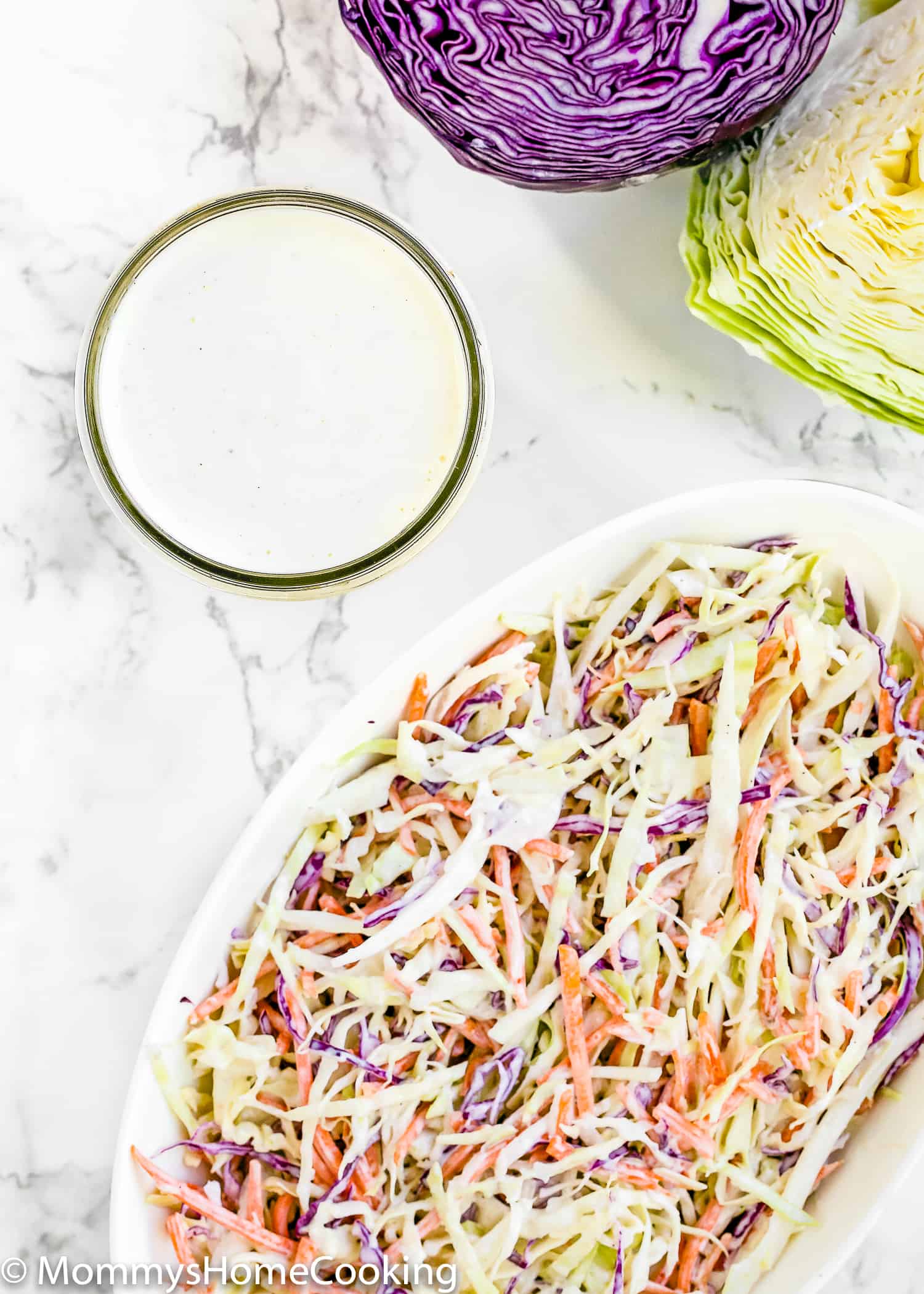 coleslaw in a bowl with dressing on the side. 