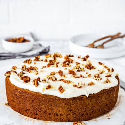 Eggless Banana Cake with frosting over a marble surface