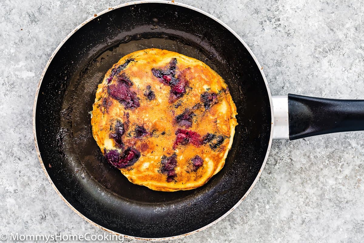 cooked Eggless Blueberry Pancake in a skillet.