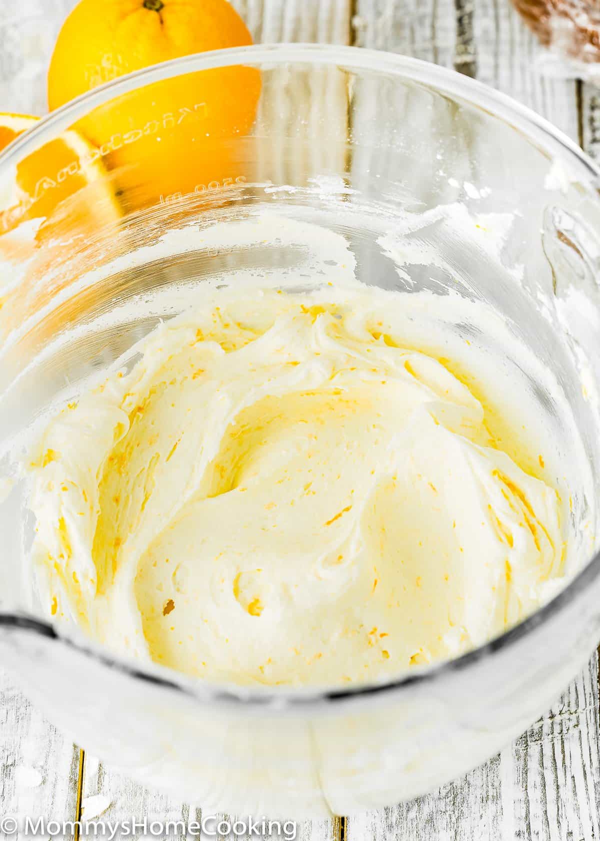 orange buttercream in a glass bowl.