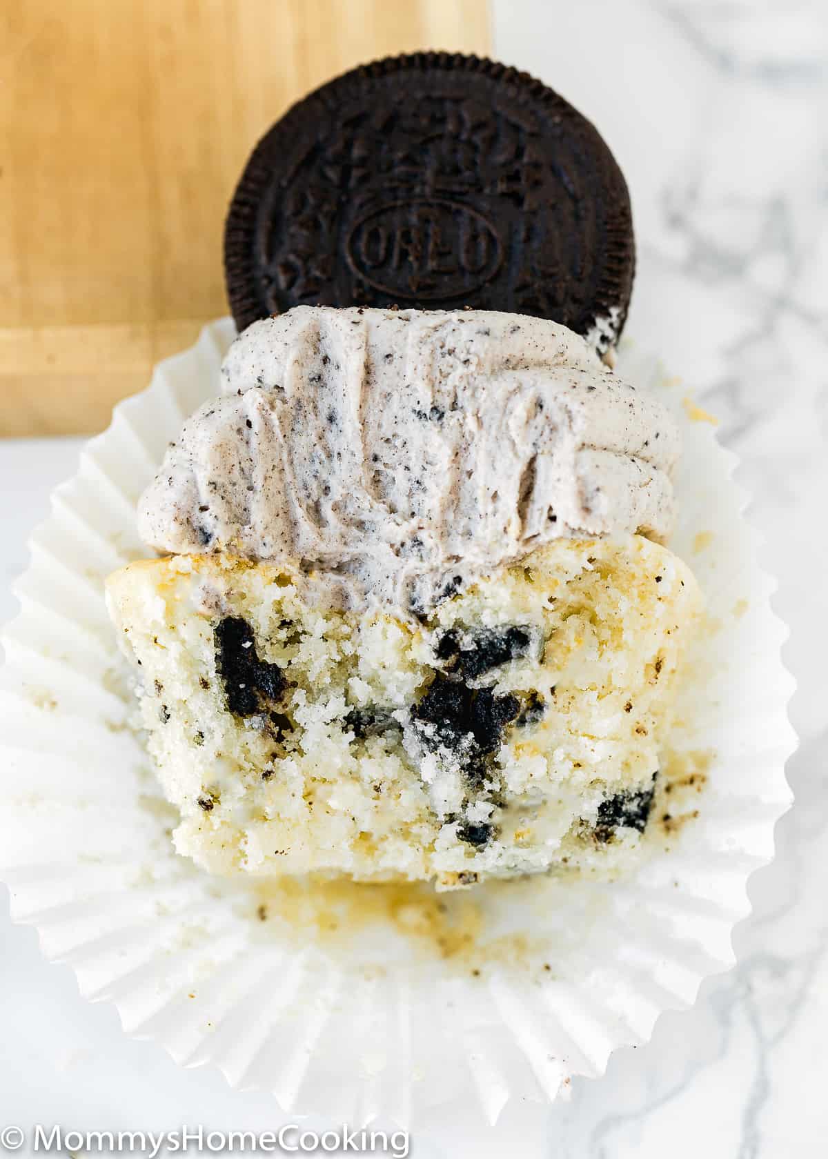eggless oreo cupcakes bitten showing its interior fluffy texture.