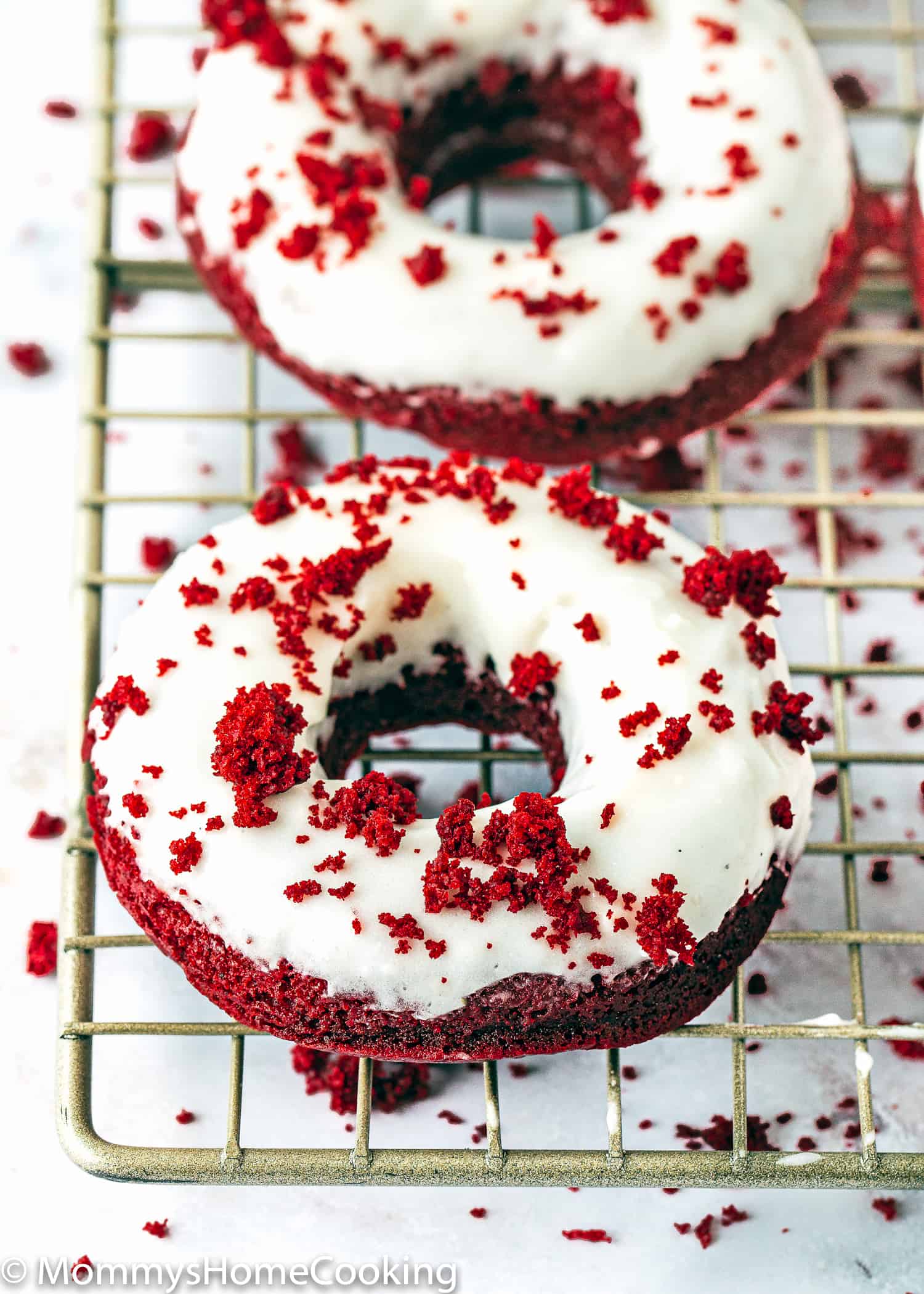 Eggless Red Velvet Donuts over a cooling rack