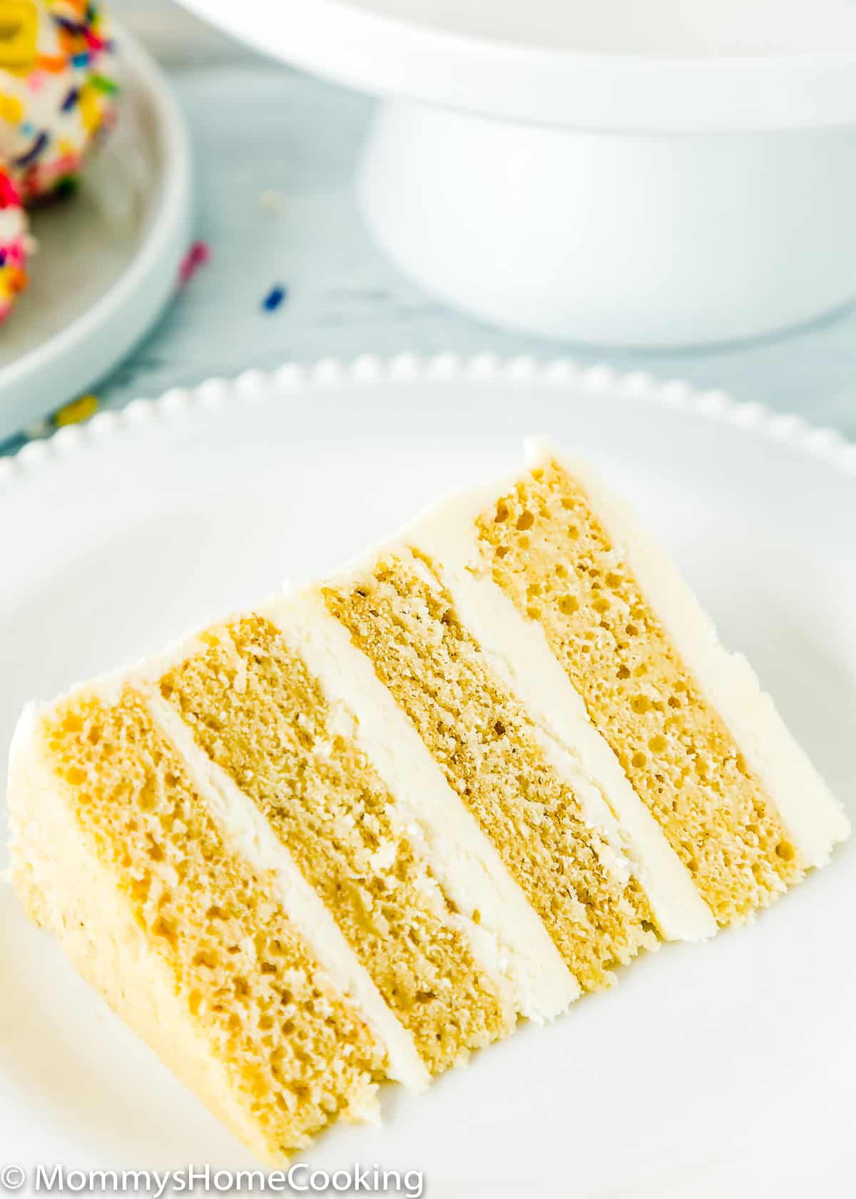 closeup view if a slice of eggless smash cake on a plate