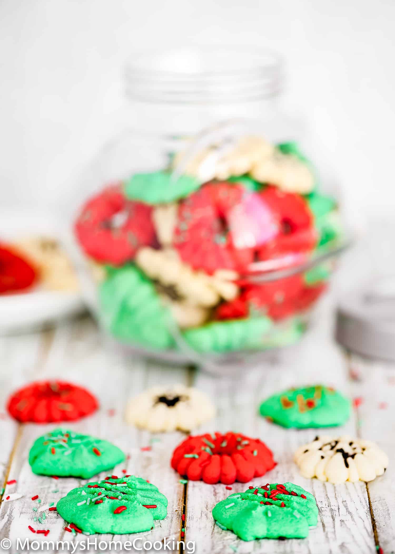 Eggless Spritz Cookies over a wooden surface. 