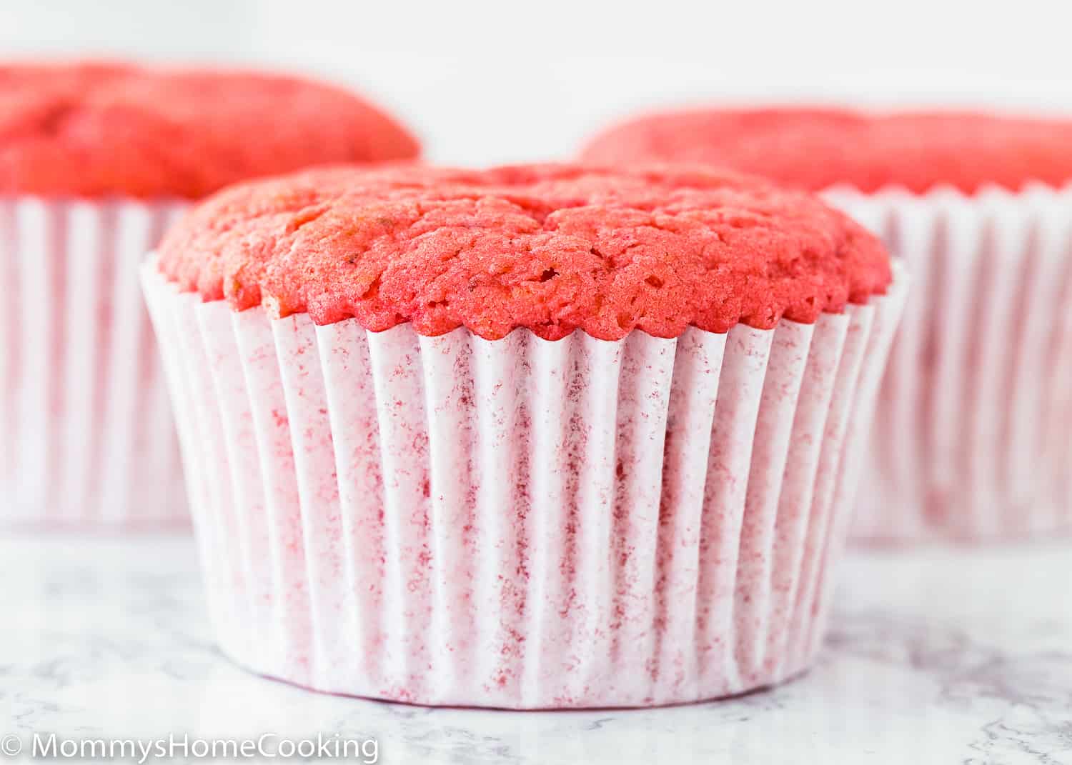 egg-free Strawberry cupcake over a marble surface.