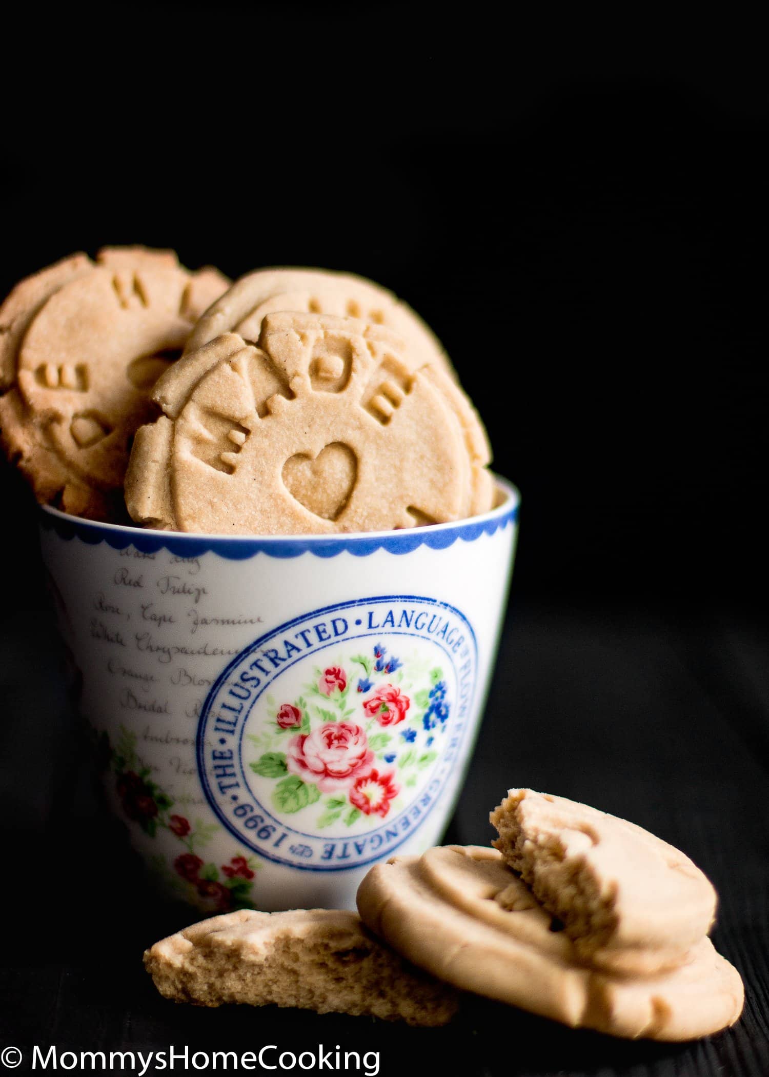 Easy Eggless Vanilla Cookies in a floral cup over a black surface 