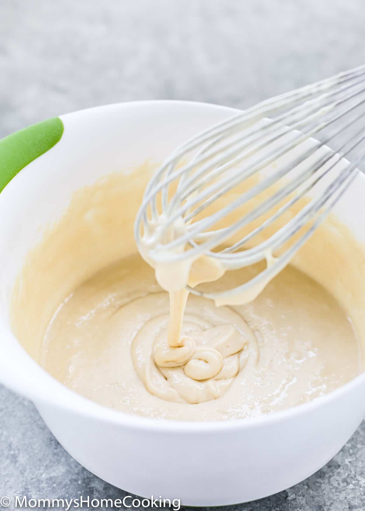 eggless waffles batter in a bowl with a whisk
