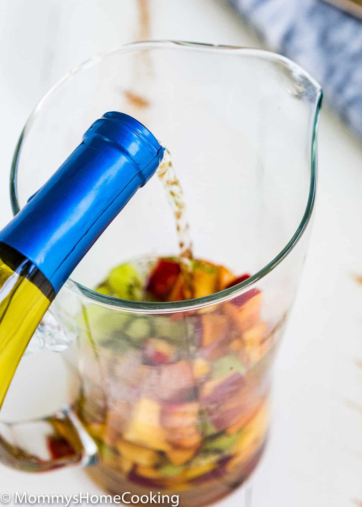 wine being poured in a glass pitcher