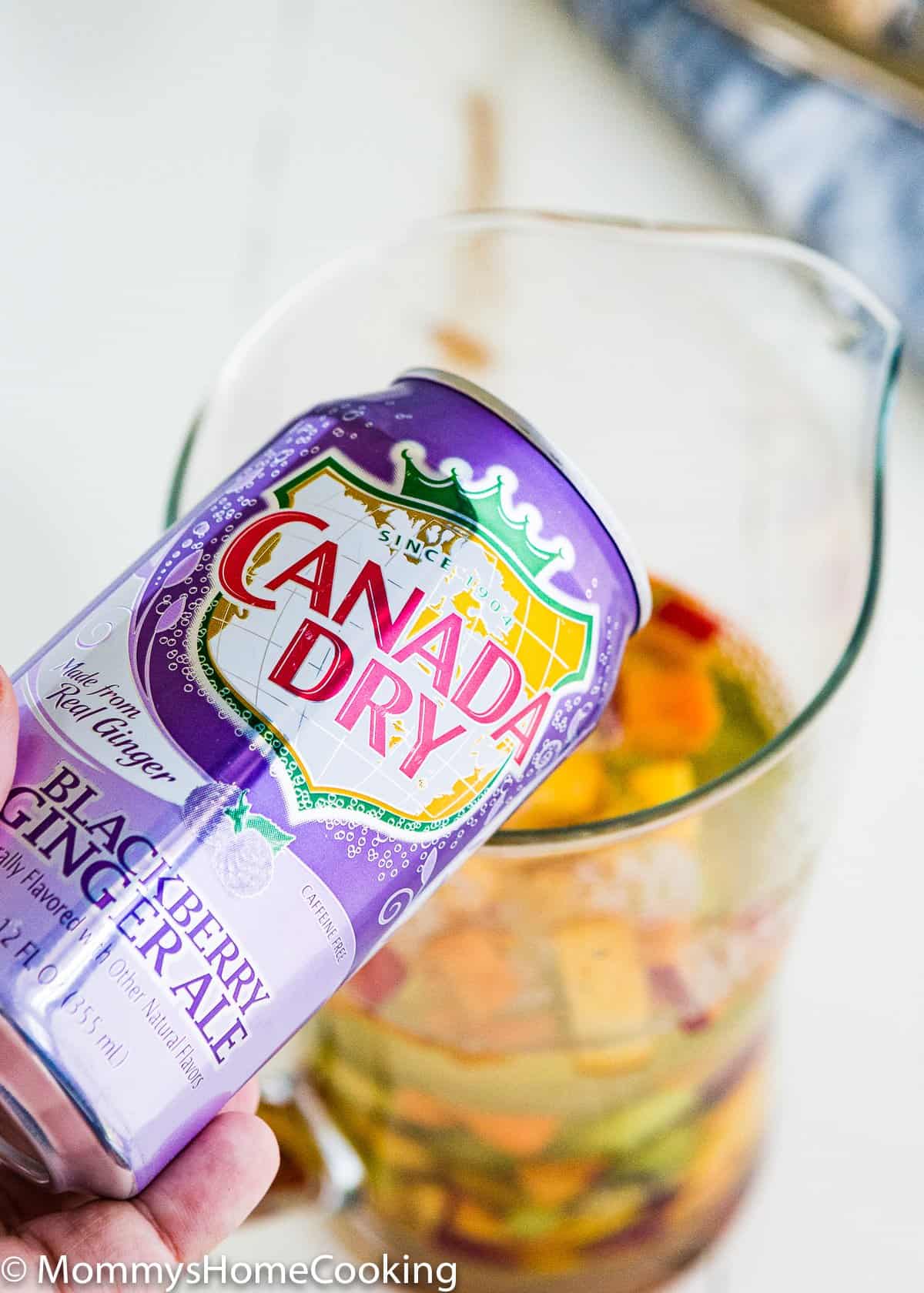 ginger ale being poured in a jar