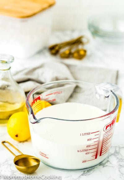 homemade buttermilk Substitute in a glass measuring cup with a spoon on the side.