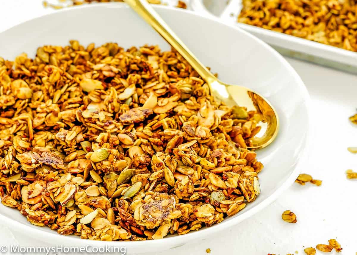 close up view of Pumpkin Pie Granola in a plate with a spoon