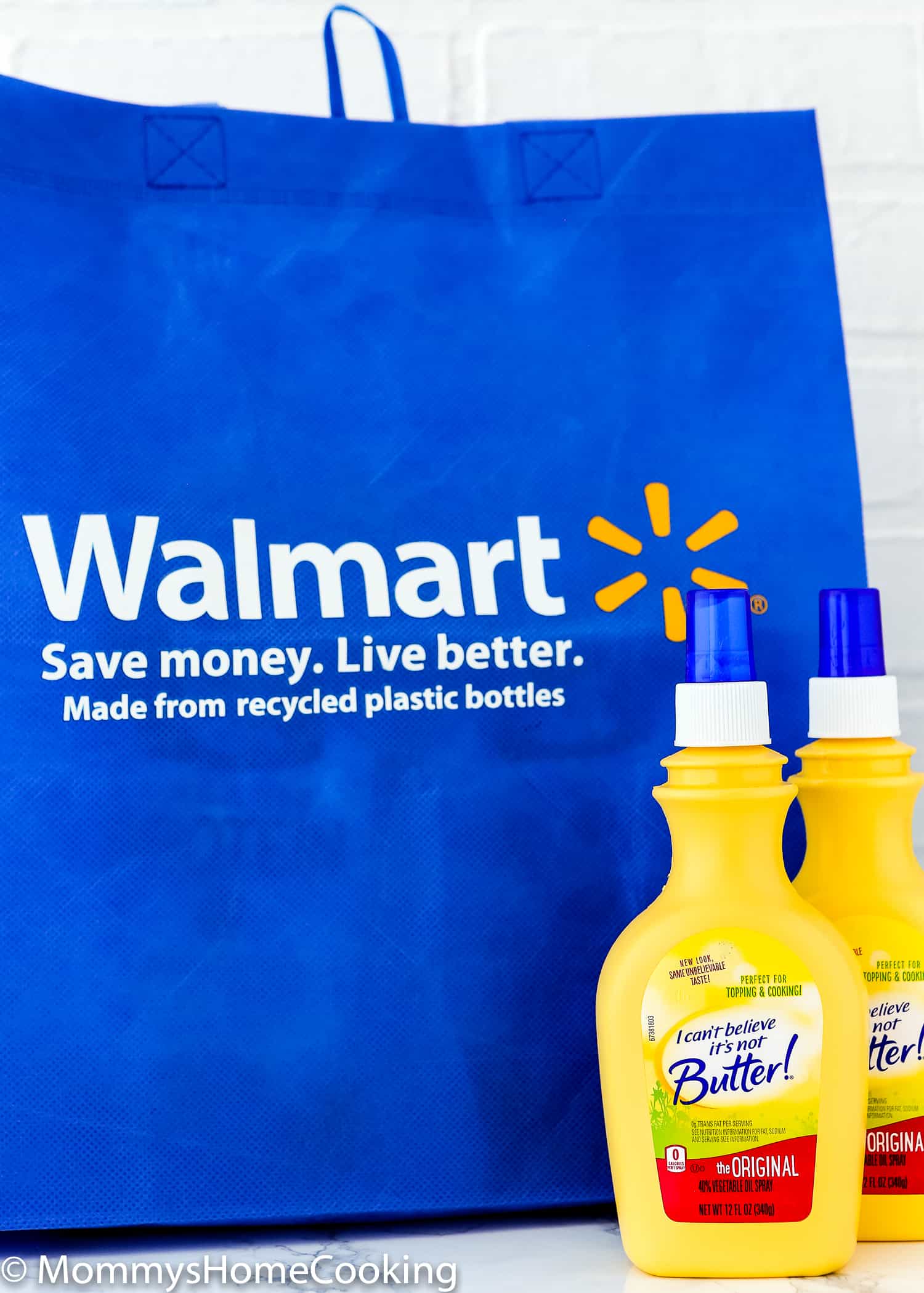 two bottles of I Can’t Believe It’s Not Butter! Original Spray  and a Walmart blue bag