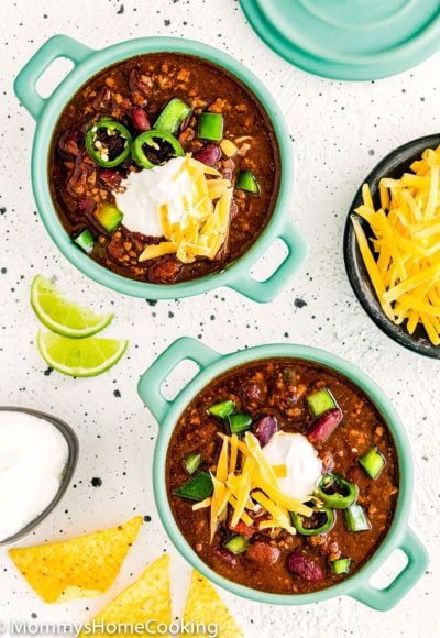 two bowls of instant pot chili with sour cream and cheese