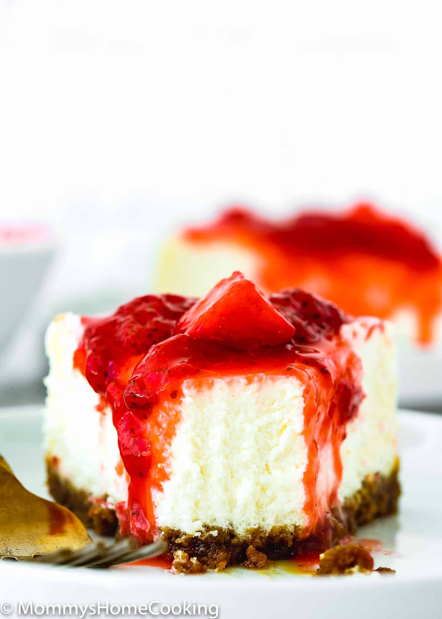 slice of eggless cheesecake cover with strawberry sauce/topping.