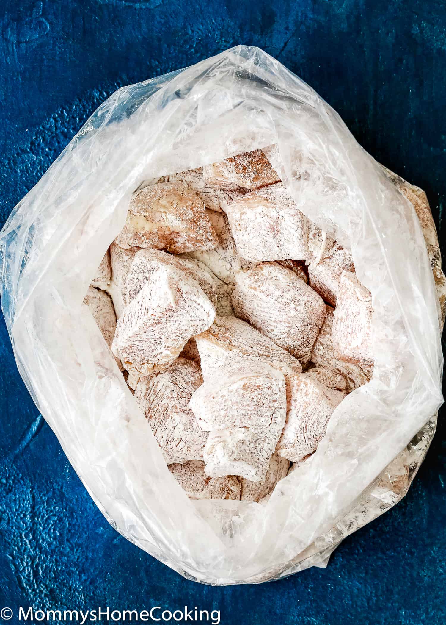 chicken pieces in a plastic bag coated with cornstarch 