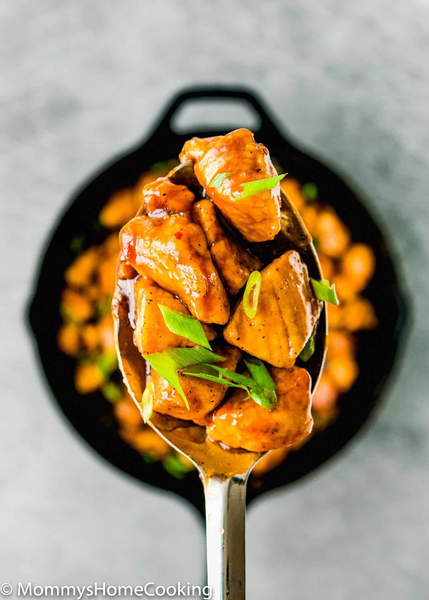 How to Make Easy Sticky Bourbon Chicken on a serving spoon