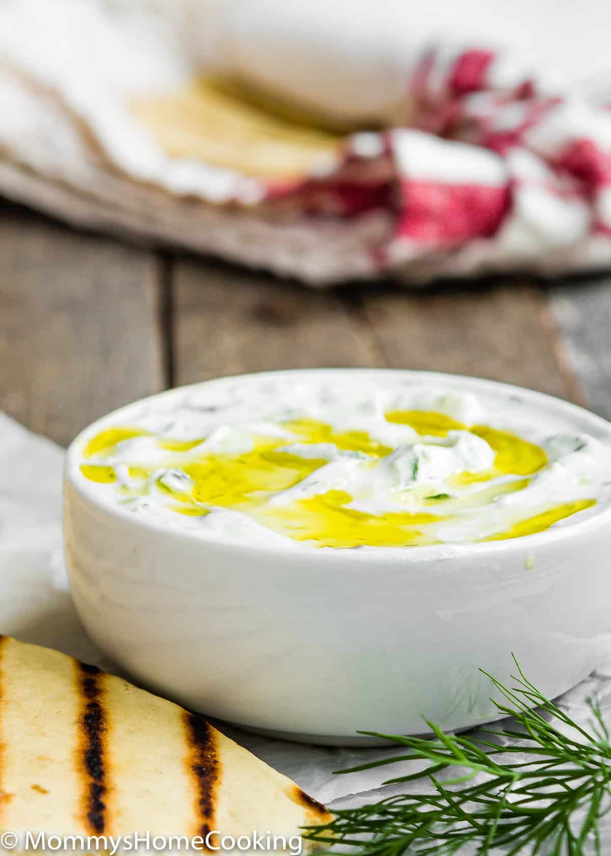 Tzatziki Sauce [Greek Yogurt Sauce] in bowl drizzled with olive oil