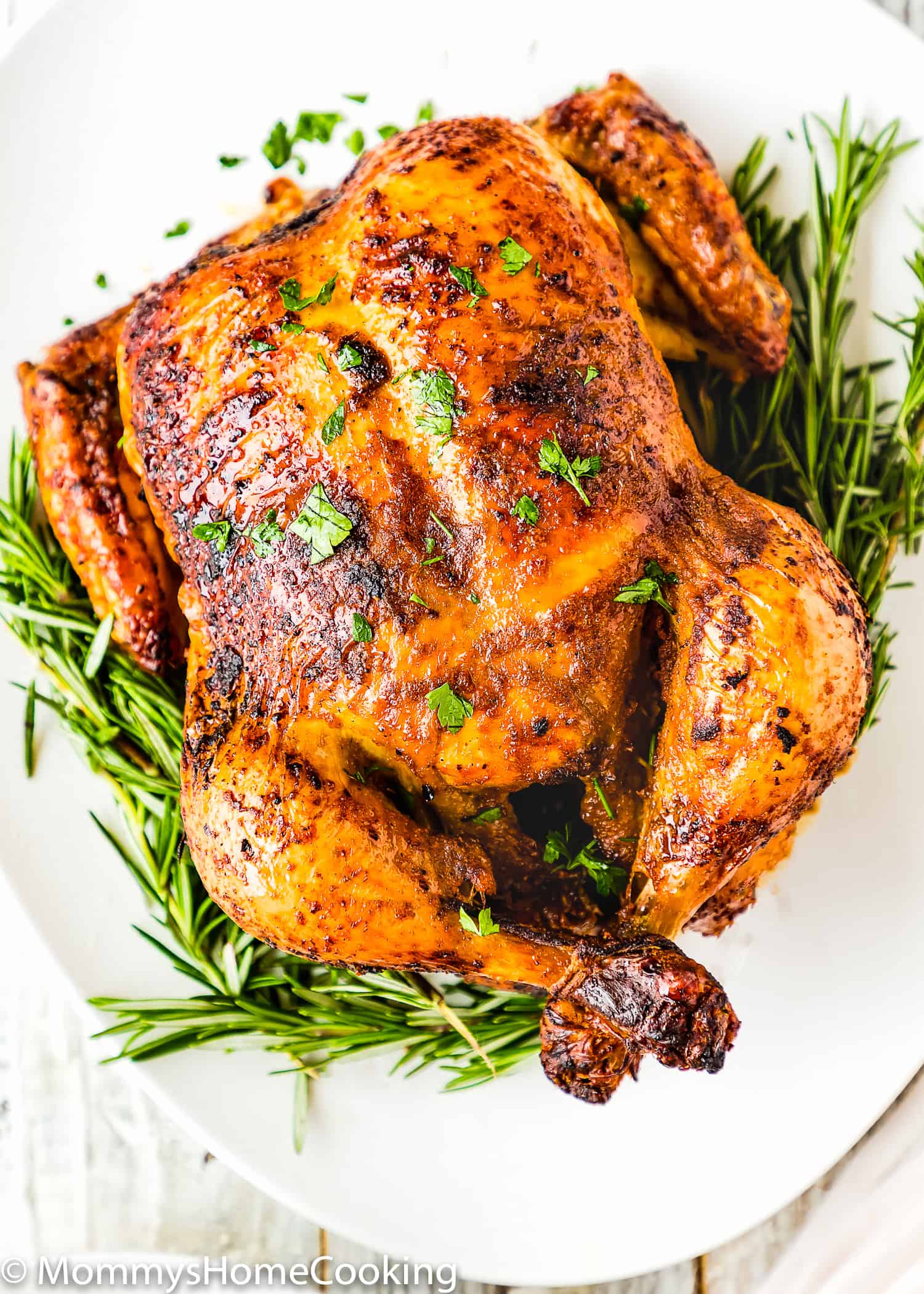 Venezuelan style roasted chicken in a white serving plate.