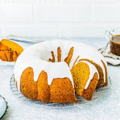 sliced egg-free pumpkin bundt cake over a cooling rack.