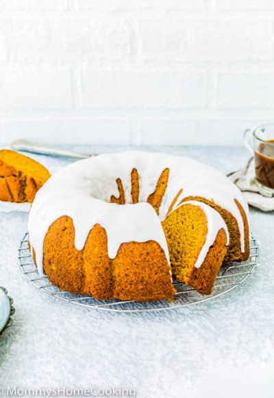 sliced egg-free pumpkin bundt cake over a cooling rack.