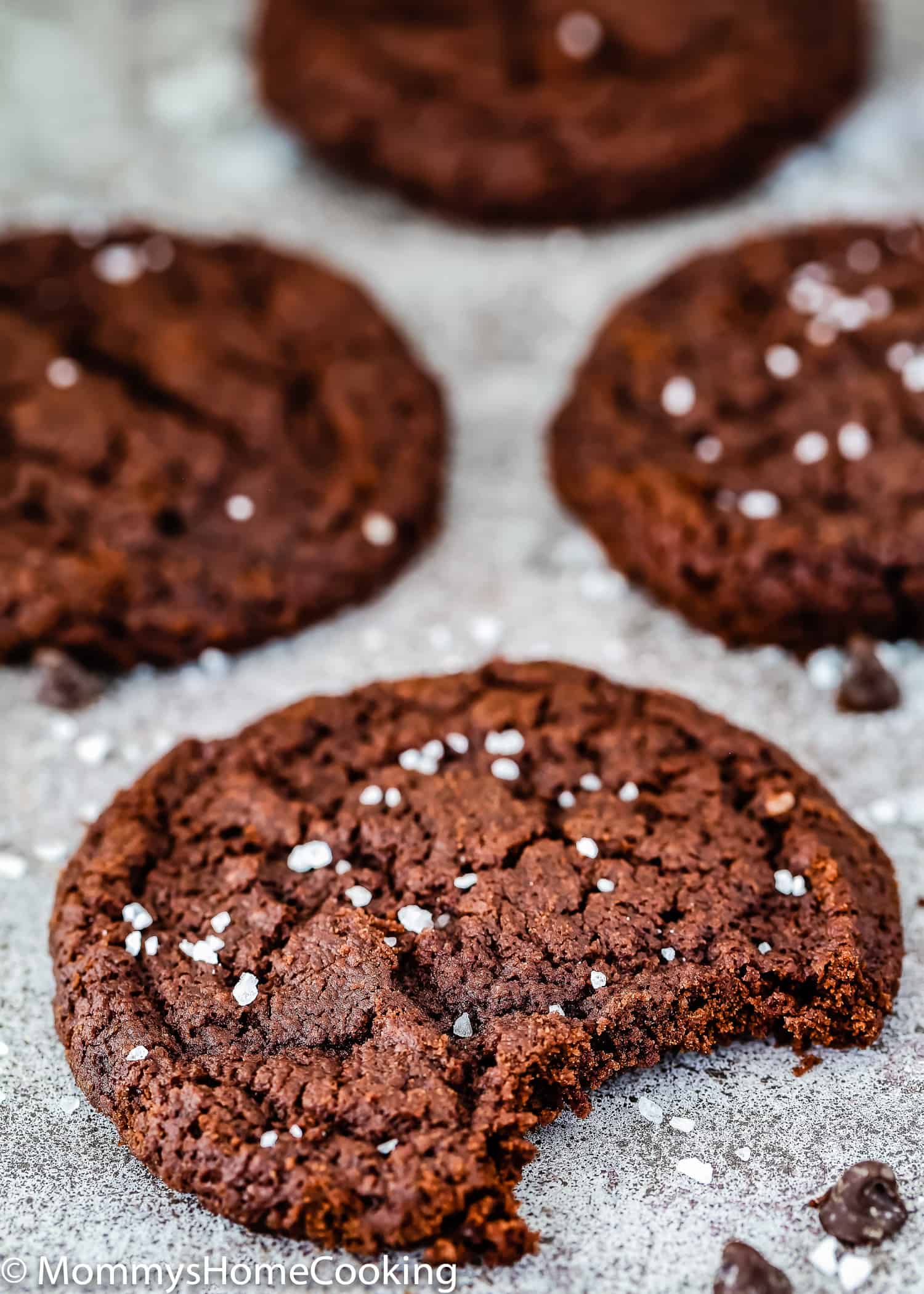 Eggless Double Chocolate Cookie bitten over a gray surface.