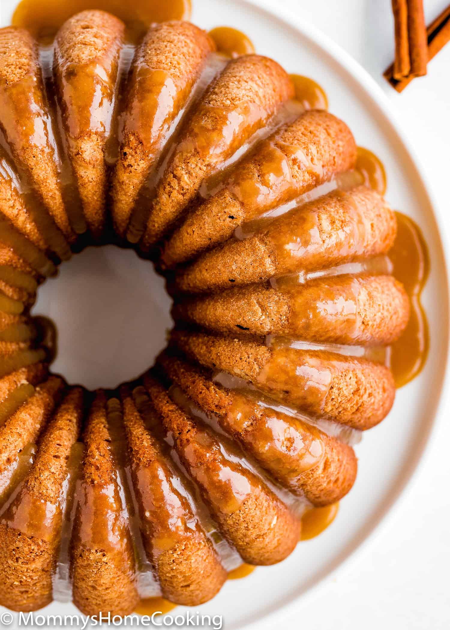 overhead view of a Eggless Apple Cider Donut Cake with brown sugar glaze.