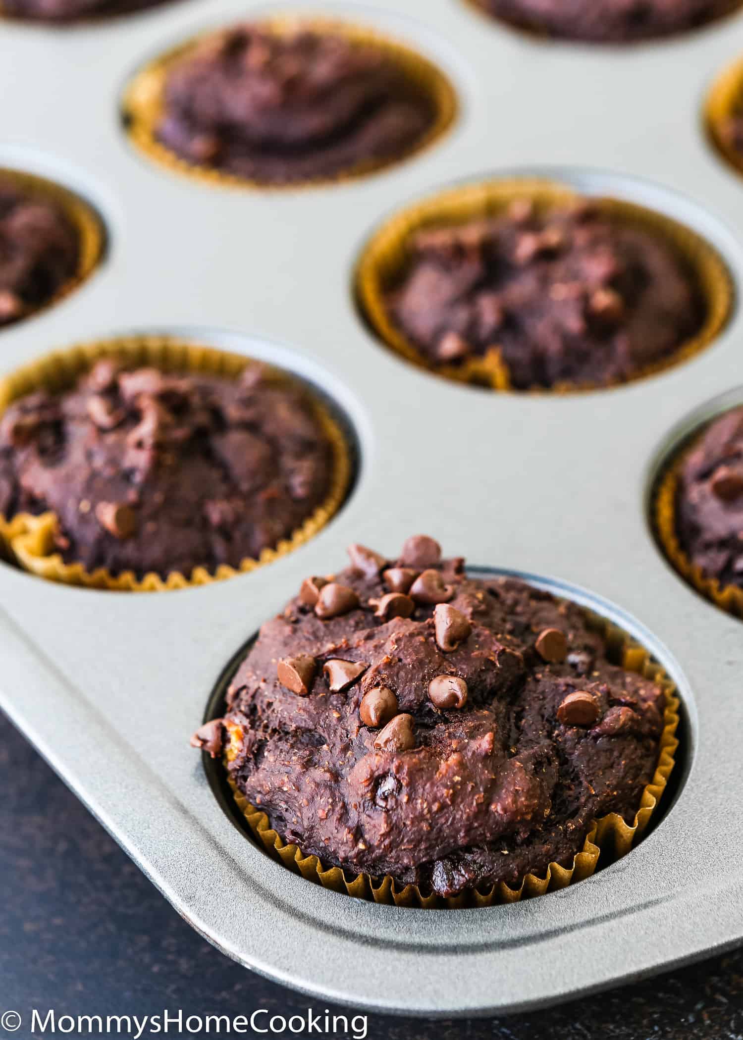 baked Eggless Banana Chocolate Muffins in a muffin pan.