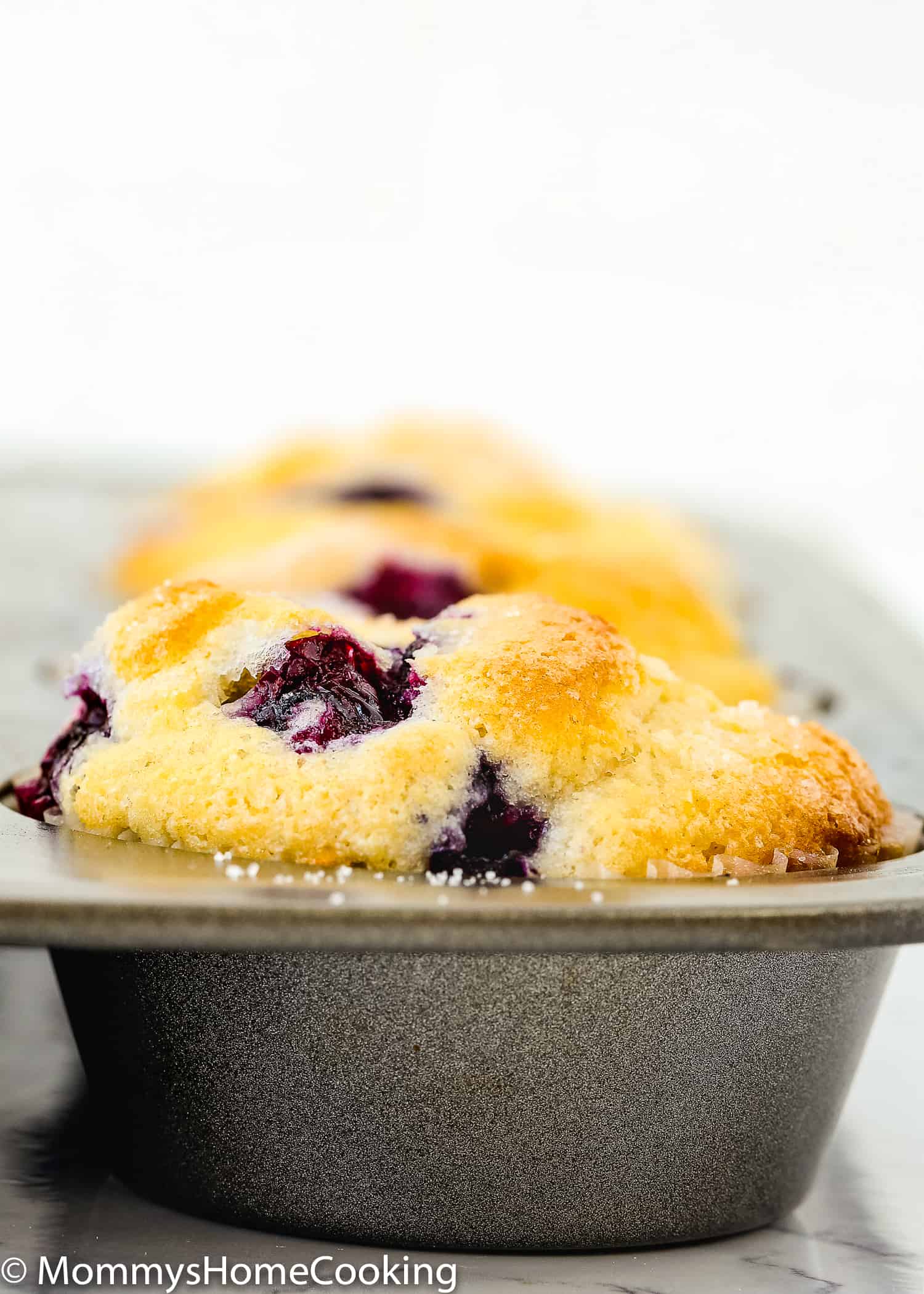 baked Eggless Blueberry Muffin in a muffin tin.