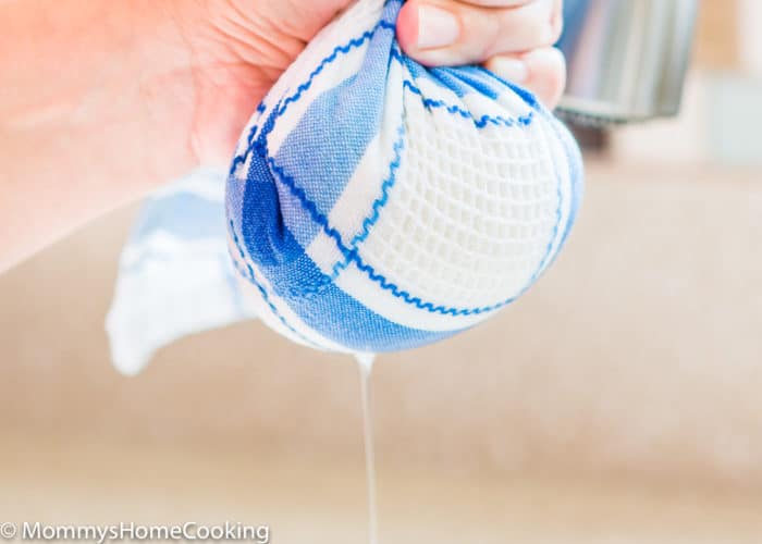 a hand squeezing Cauliflower rice