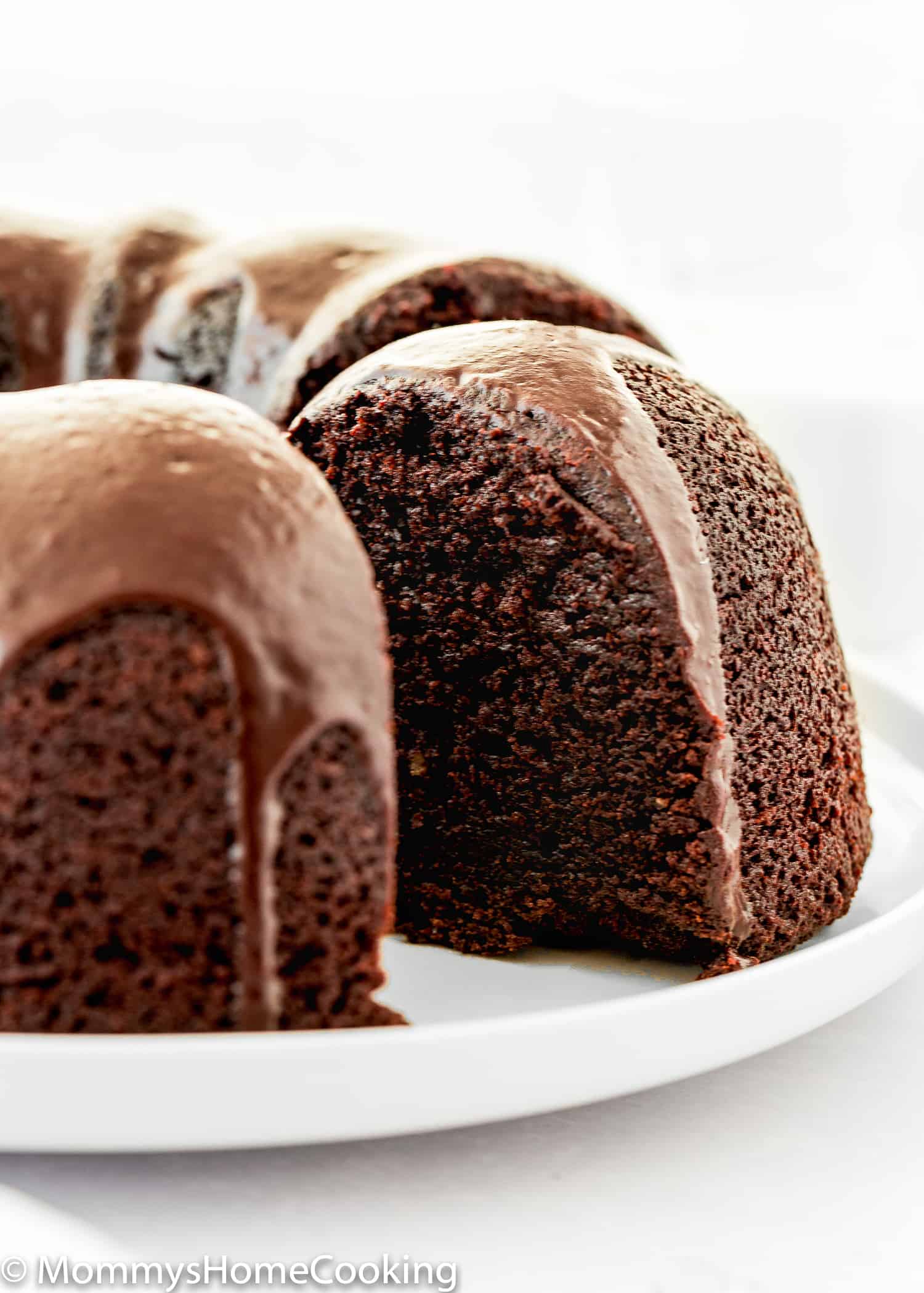 Sliced Eggless Chocolate Bundt Cake over a white plate. 