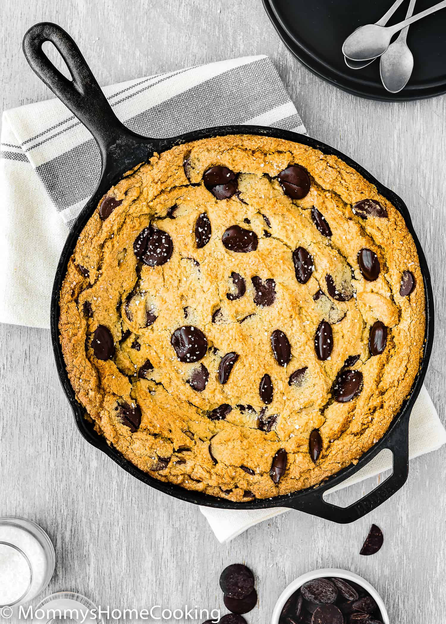 Eggless Chocolate Chip Skillet Cookie over a kitchen towel.