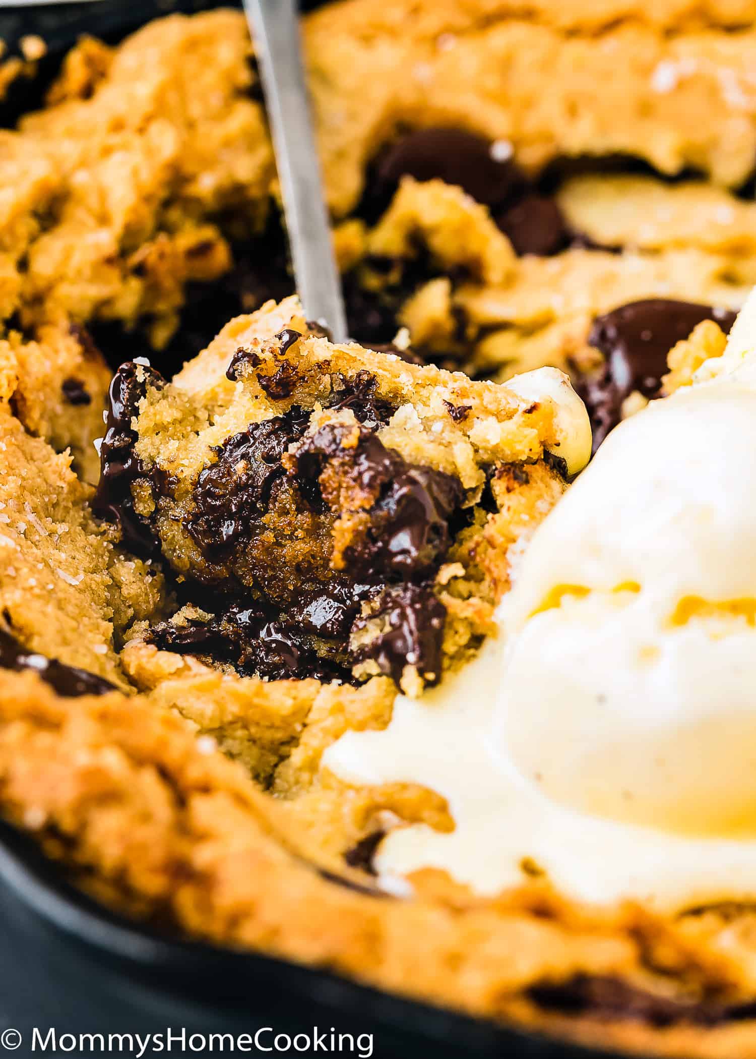 a spoon with Eggless Chocolate Chip Skillet Cookie and ice cream.