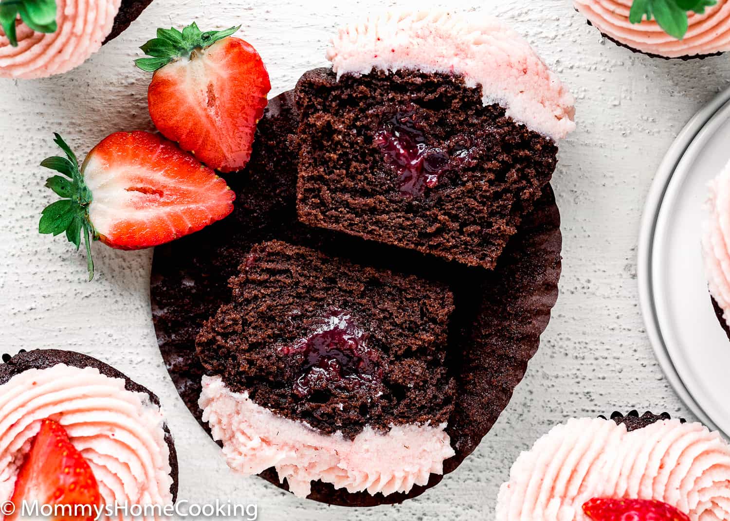 Eggless Chocolate Strawberry Cupcakes cut in half showing its fluffy texture. 