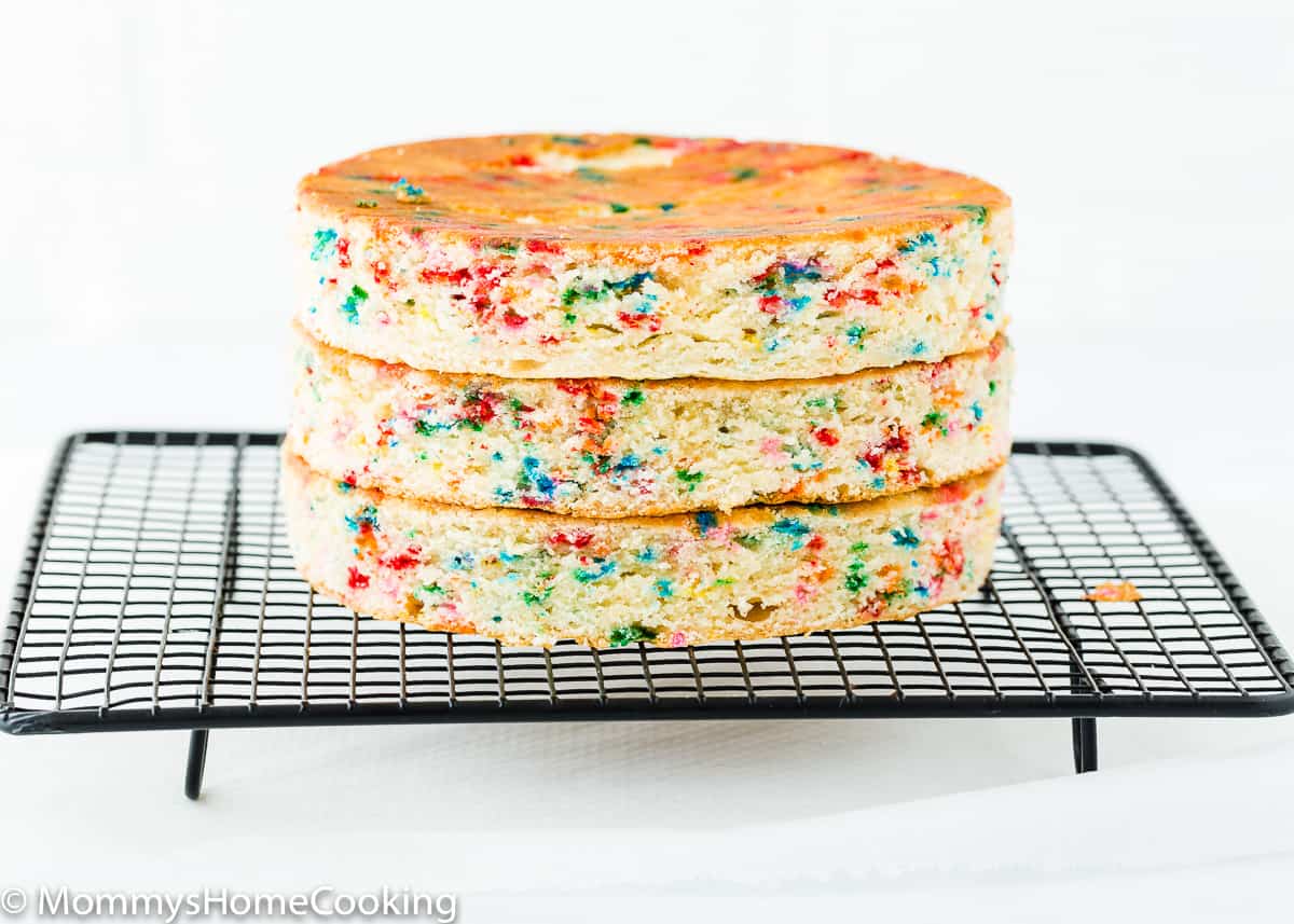 three layers of egg-free cake on a cooling rack.