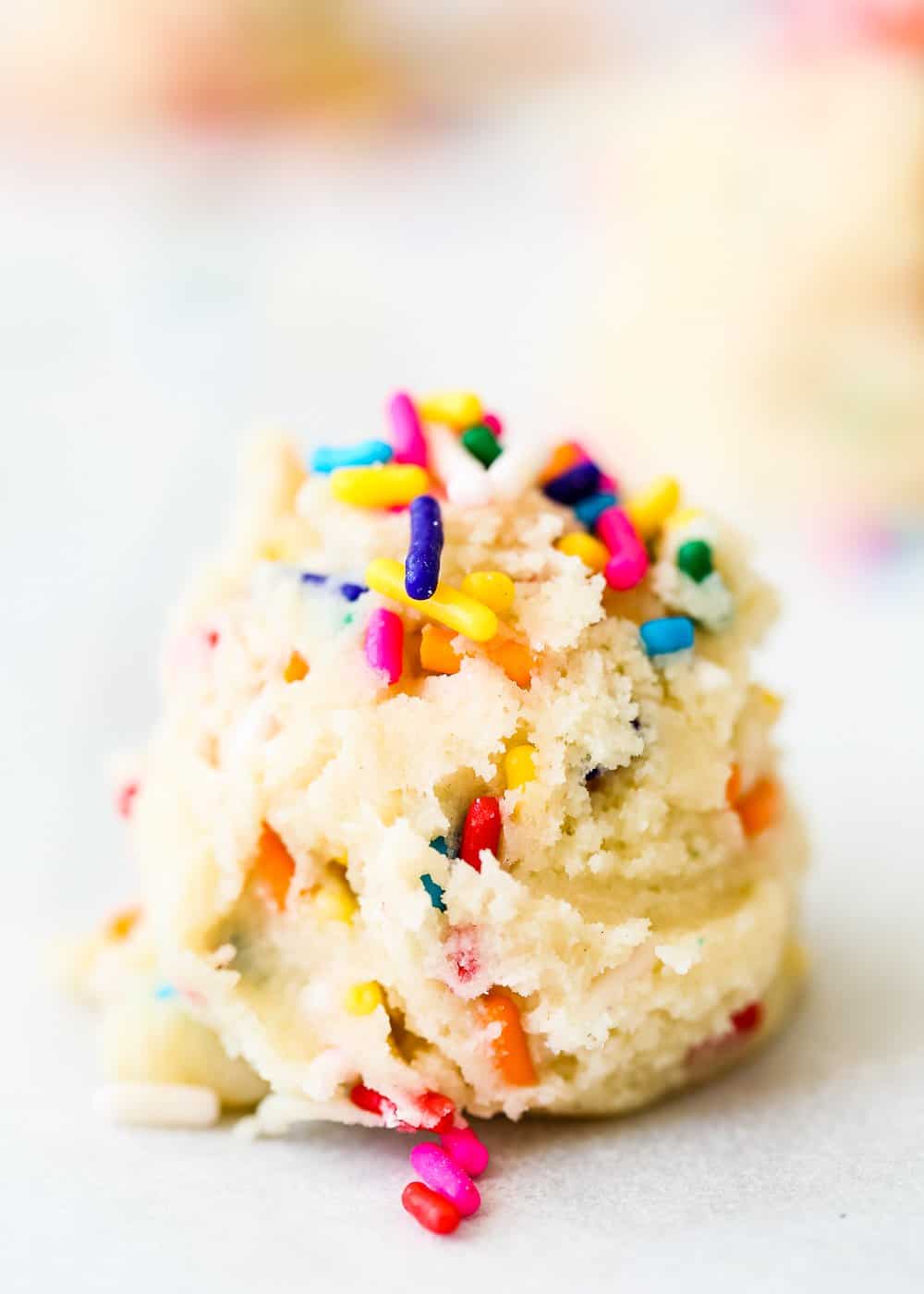 a mound of egg-free cookie dough with sprinkles on top. 