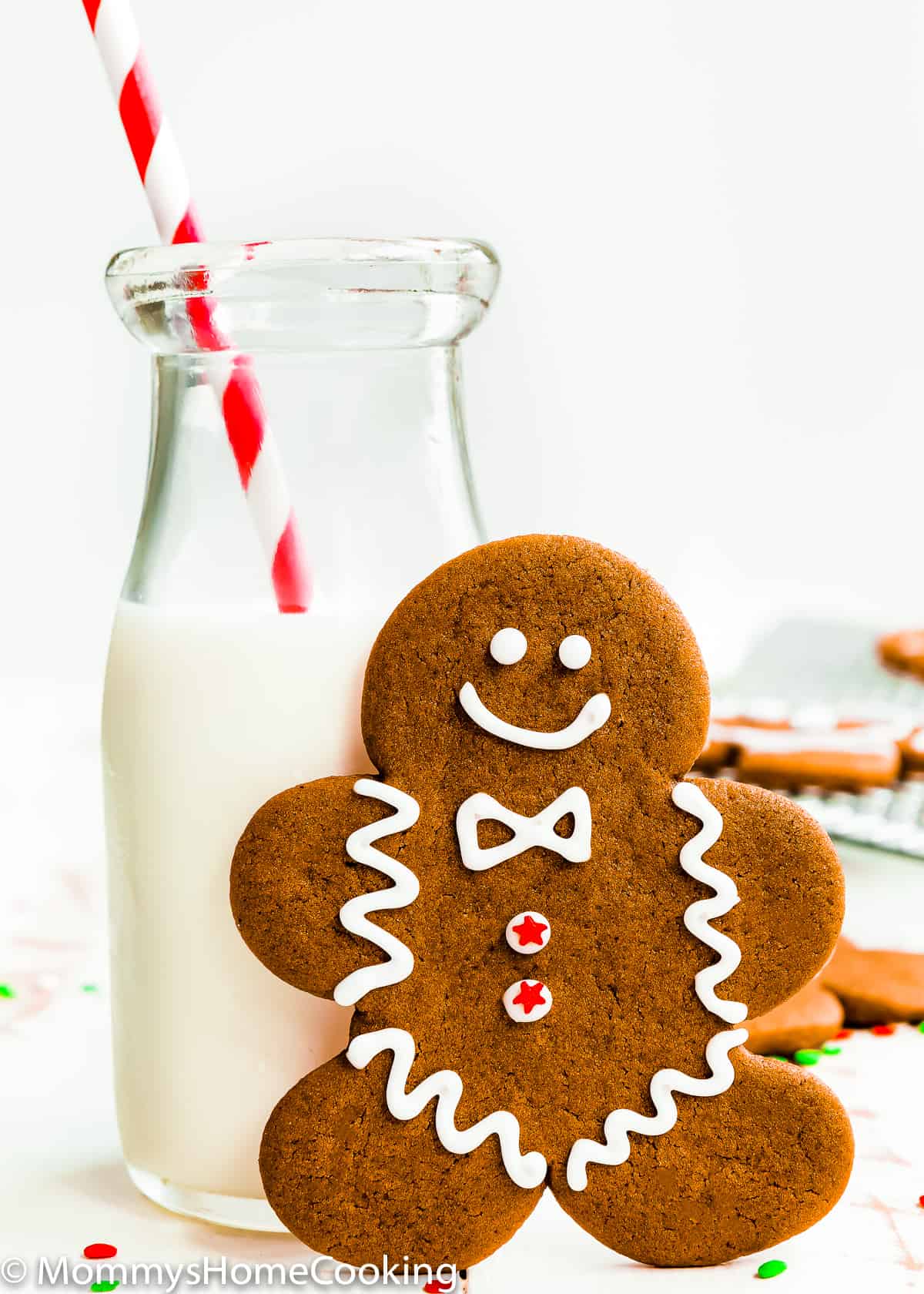 Eggless Gingerbread Cookie with a jar with milk and a red straw.