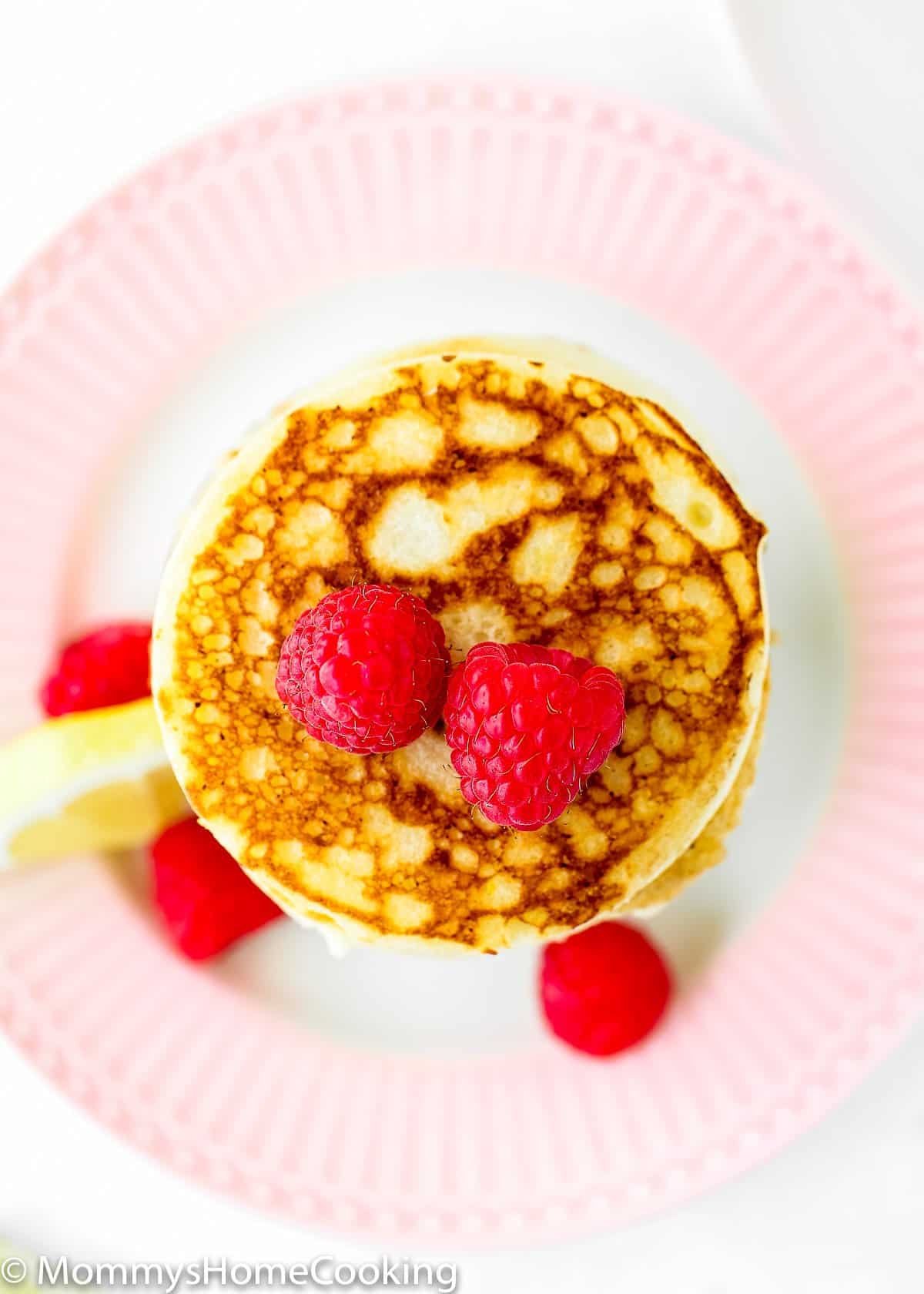 overhead view of a eggless lemon ricotta pancakes stack.