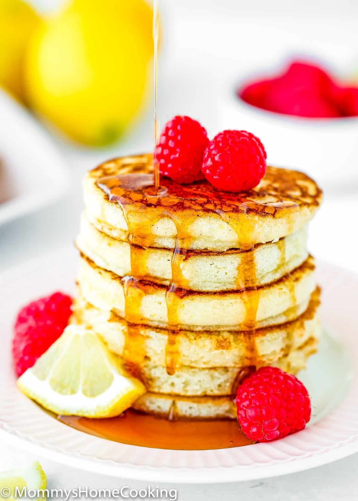 maple syrup poured onto a stack of eggless lemon ricotta pancakes. 