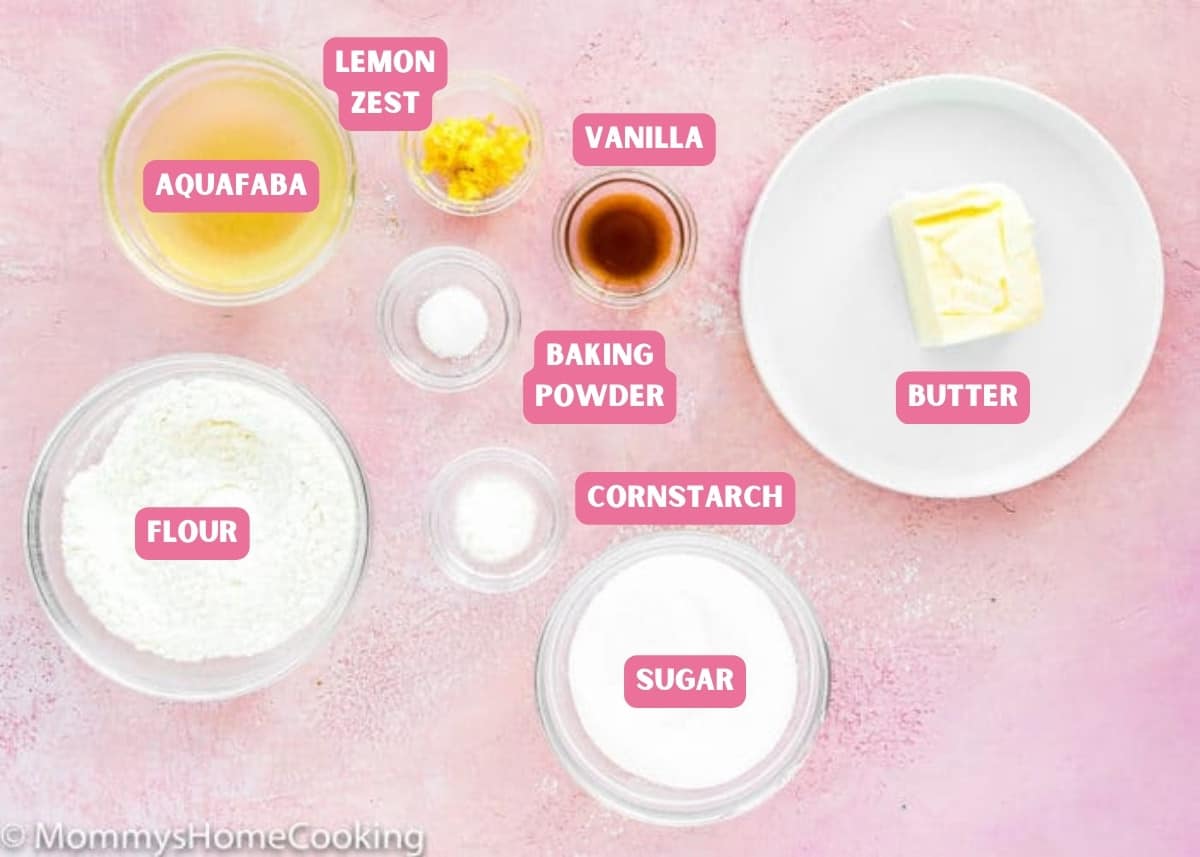 ingredients needed to make Eggless Madeleines over a pink surface with name tags.