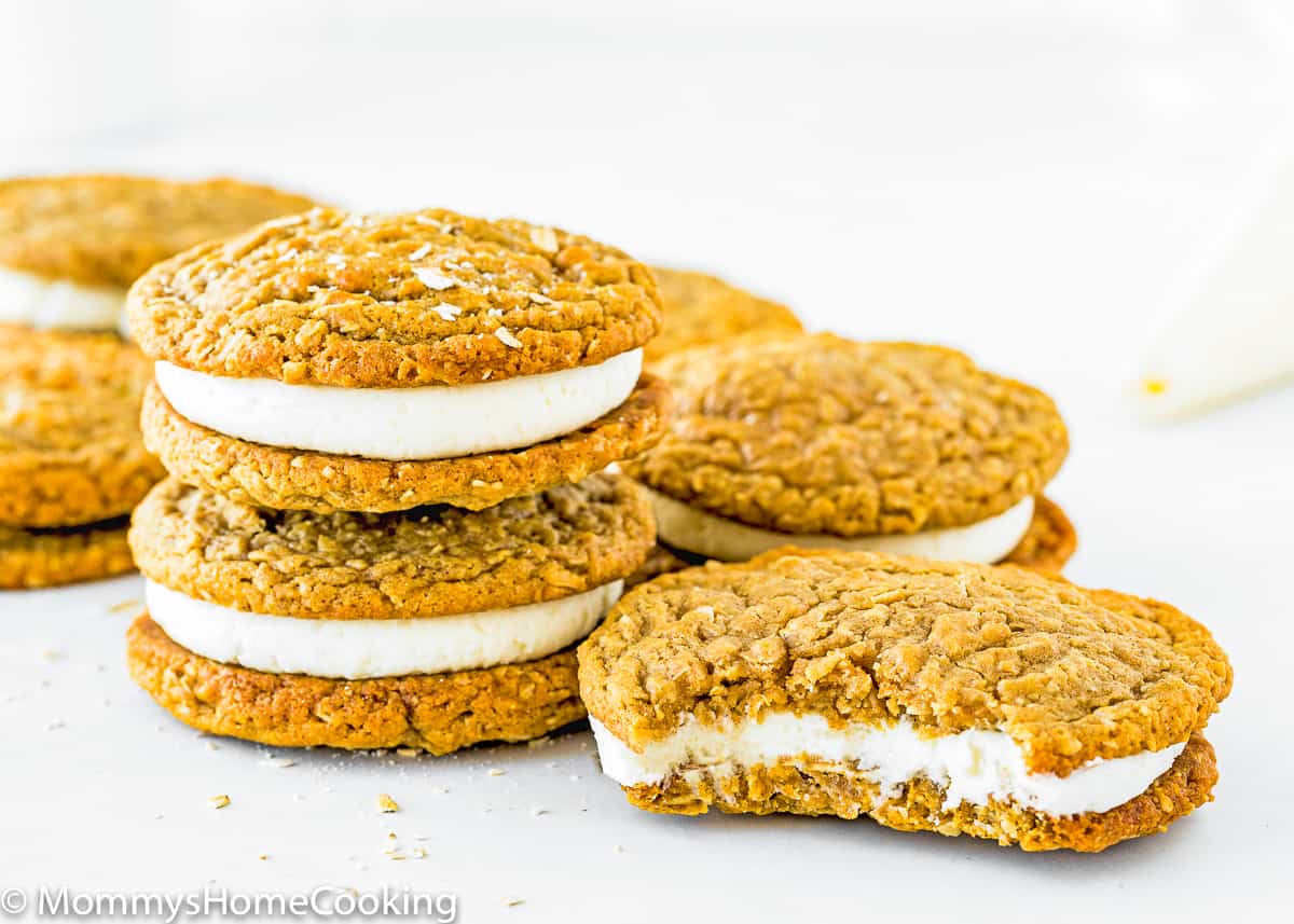 bitten Eggless Oatmeal Cream Pie cookie over a white surface.