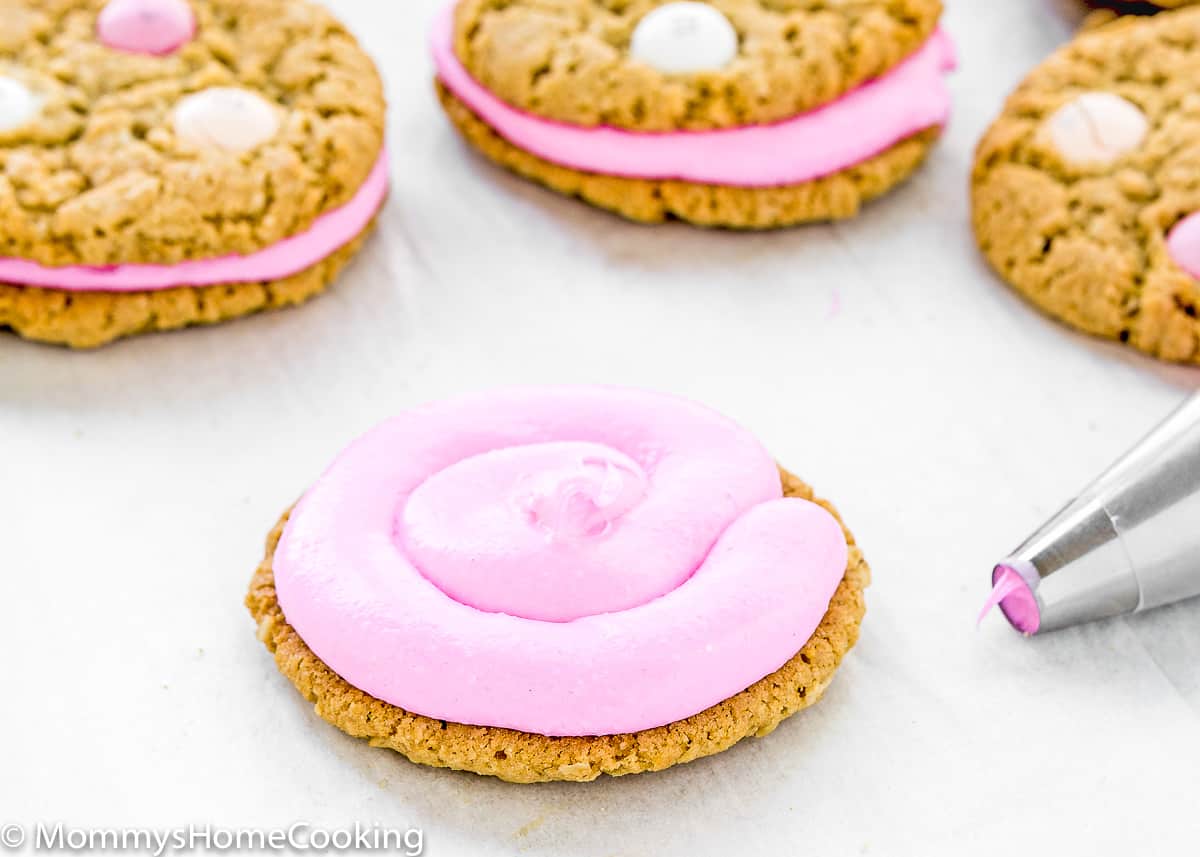 a egg-free oatmeal cookies with pink frosting on it.