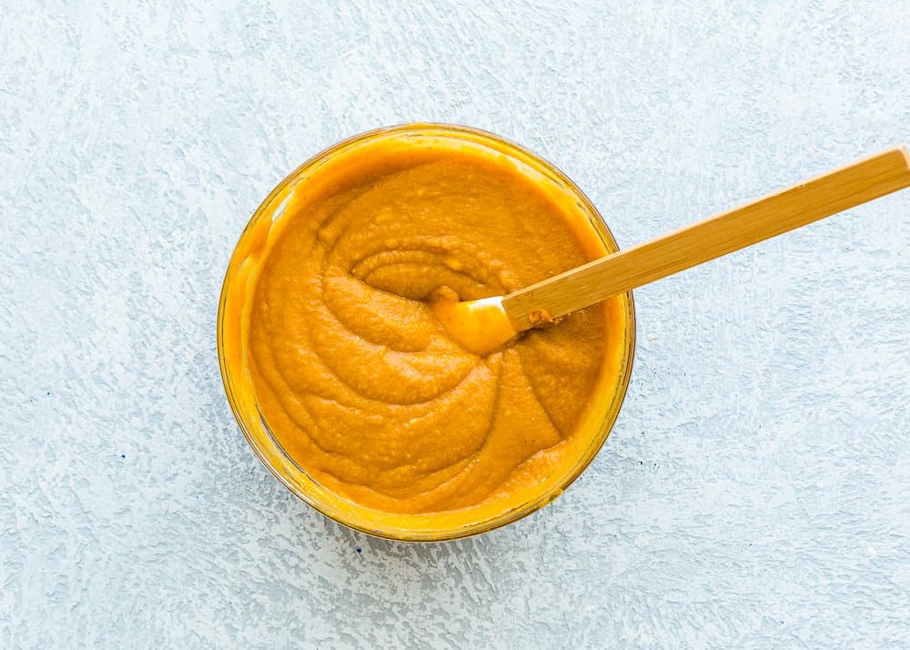 wet ingredients needed to make egg-free pumpkin cake in a bowl.